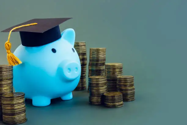 savings for college. piggy bank with graduation cap.